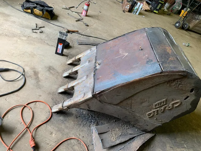 Excavator bucket repair and rebuild in the shop