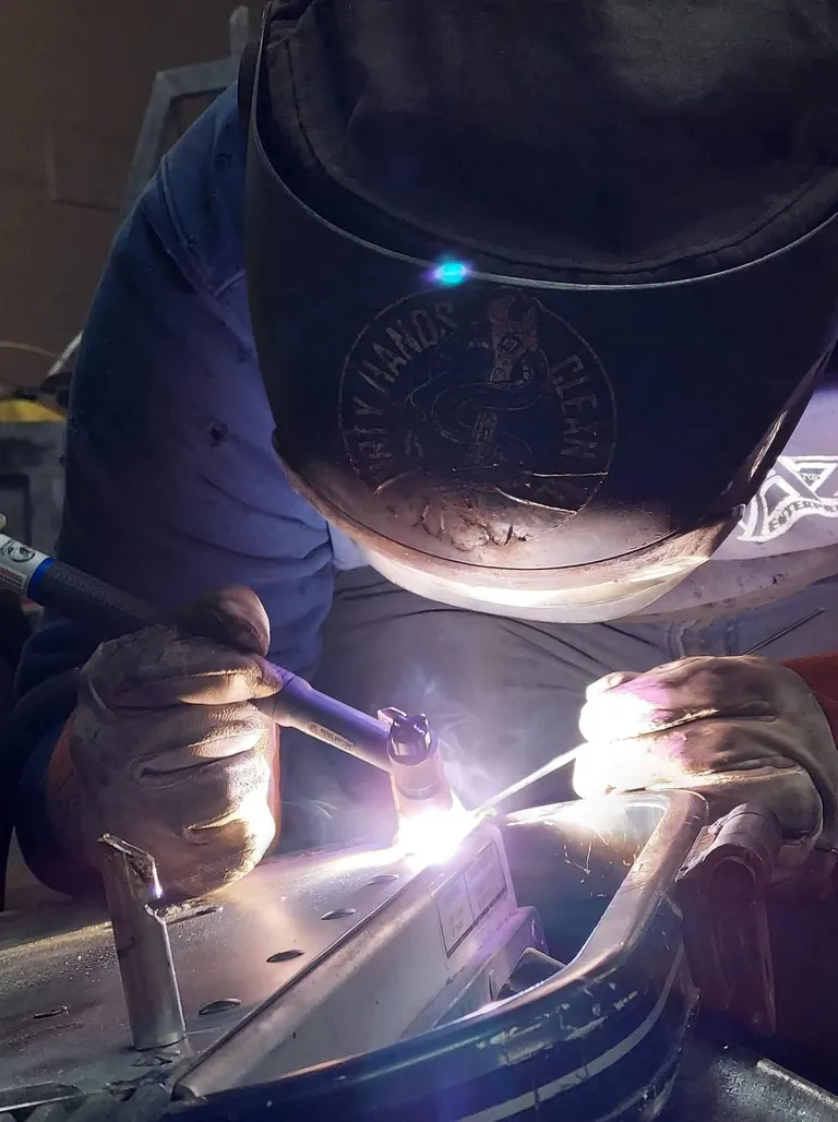 TIG welding close-up showing precision bead work