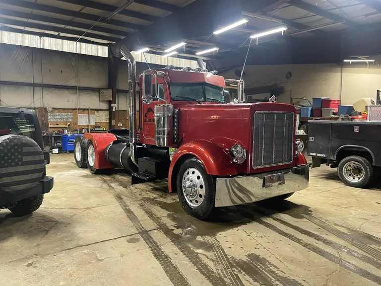 Red Peterbilt truck frame work at McMahons shop
