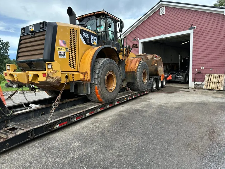 CAT 966K wheel loader on flatbed for heavy equipment service