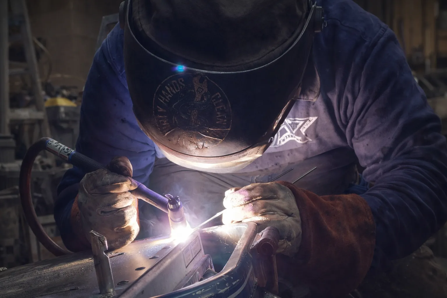 McMahons Welding Services workshop with sparks flying during precision metal fabrication in Lyman, Maine